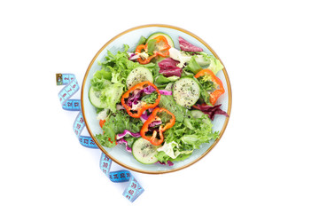 Plate with fresh salad and measuring tape isolated on white background