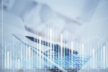 Forex graph hologram on table with computer background. Multi exposure. Concept of financial markets.