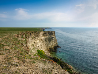 Fototapeta na wymiar Section of sea coast with steep textured limestone rocks