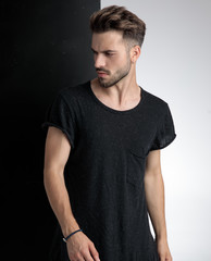 arrogant young man looking to side in studio