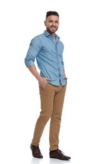 casual man walking with hands in pockets joyful