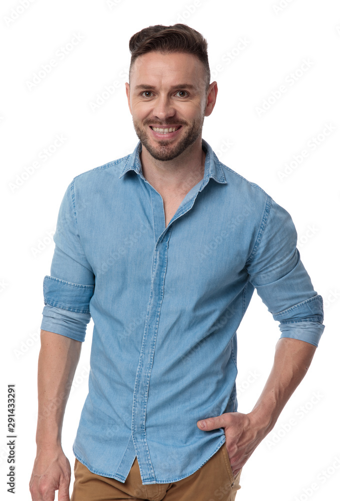 Wall mural casual man standing with hand in pocket happy