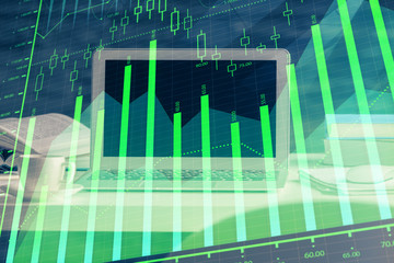 Forex market chart hologram and personal computer background. Multi exposure. Concept of investment.