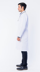 Full body shot profile view of young Persian man doctor