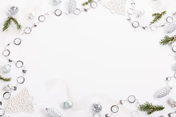 Christmas composition. Christmas white and silver decorations, on white background. Flat lay, top view, copy space