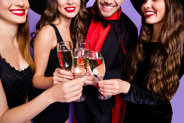 Cropped photo of three witch ladies and vampire guy chilling at halloween party little drunk wear black dresses hats and long coat isolated purple color background