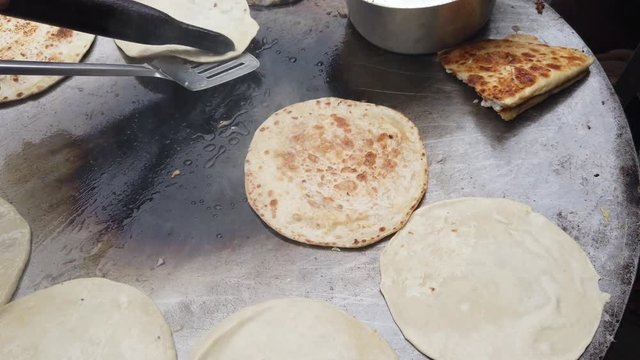 Preparation of Egg Paratha, a flatbread, originated from Indian subcontinent. Layers of cooked dough or anda parat is a healthy delicious snack with omelette stuffing with whole grain wheat flour 