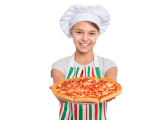 Happy beautiful teen girl in chef hat holding cooked pizza. Girl cook in apron holds plate with fresh pizza, isolated on white background. Portrait of cute child showing delicious Italian pizza. - 291435821