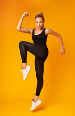 Sporty Girl Jumping Exercising On Yellow Background