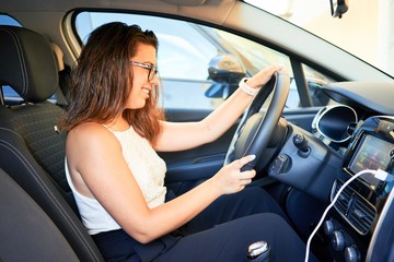 Fototapeta na wymiar Young driver woman driving car