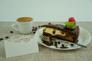 Piece of tasty chocolate cake with coffe cup and name card on white background