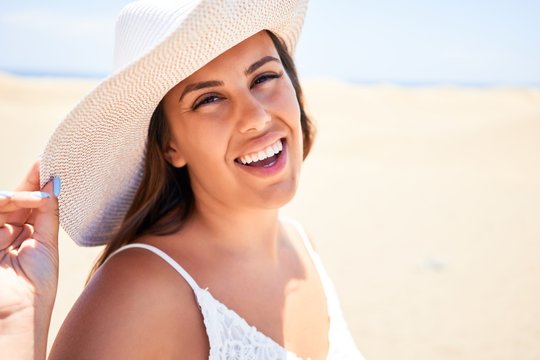 Young beautiful woman smiling happy enjoying summer vacation at maspalomas dunes beach