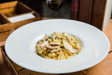 Pasta in cream sauce, Italian dinner with wine