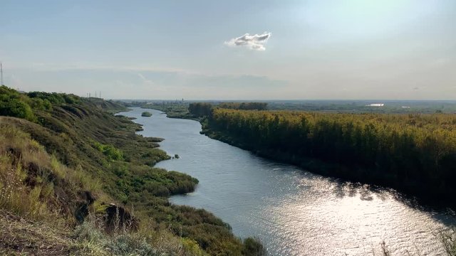 View of long river with golden autumn forest on the sunset landscape
