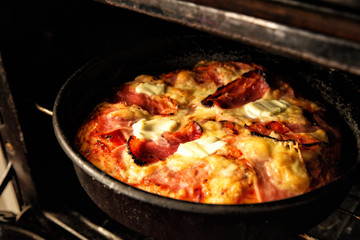 Freshly baked, homemade pizza inside the oven.