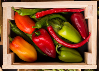 Close up of farm peppers in big wooden box