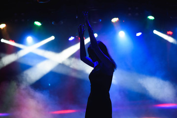 dancing silhouette of girl in a nightclub