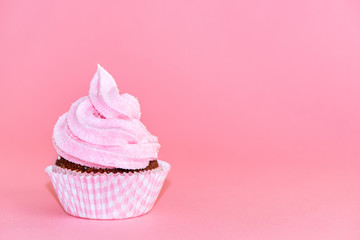 birthday cupcakes decorated whipped cream icing on pink background, concept for holiday