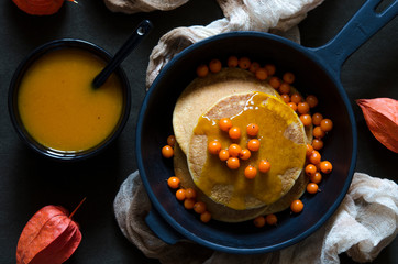 Pumpkin pancakes with sea-buckthorn sauce and berries