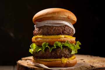 burger with beef on dark background