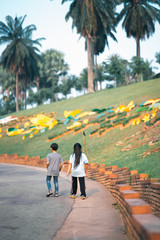 Fototapeta premium Kids walking in the park. view from behind.