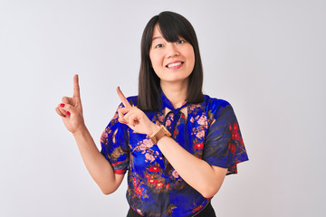 Young beautiful chinese woman wearing summer floral t-shirt over isolated white background smiling and looking at the camera pointing with two hands and fingers to the side.