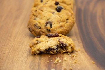 Pile of delicious tasty recipe apple cookies homemade with bite isolated on wooden table