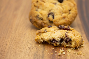 Pile of delicious tasty recipe apple cookies homemade with bite isolated on wooden table