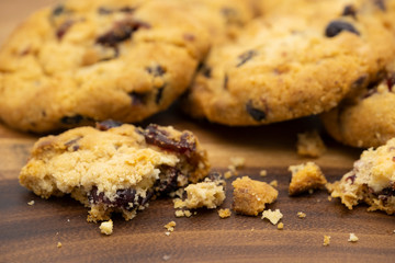 Pile of delicious tasty recipe apple cookies homemade with crack small pieces isolated on wooden table