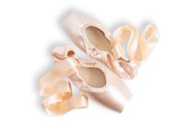 New pink ballet pointe shoes isolated on white background