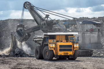 Open mountain quarry. Loading coal into a mining truck.