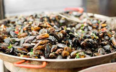 Close up of mussels in sauce in big bowl