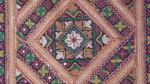 Detail old colorful patchwork carpet, establishing shot. Close up