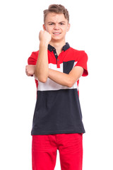 Portrait of teen boy making Bad gesture with hands, isolated on white background. Handsome caucasian young teenager showing obscene sign. Upset child looking at camera.