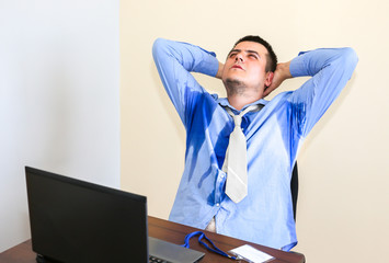 Sweating office worker. Wet shirt. Bad work conditions. Unhappy manager. Summer heat. No air...