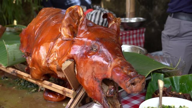 Roasted pig on the traditional barbecue. Grilled pig on the market of Bali, Indonesia, close up