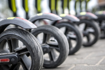 Wheels of parked electric scooters.