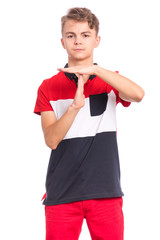 Emotional portrait of Teen Boy making timeout gesture, isolated on white background. Serious child tired and bored looking at camera and showing pause or time out sign. Student asking for time-out.