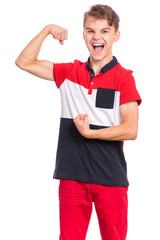 Portrait of teen boy raised his hands and shows biceps, isolated on white background. Handsome teenage young boy shows biceps screaming. Shouting strong child flexing biceps and looking at camera.