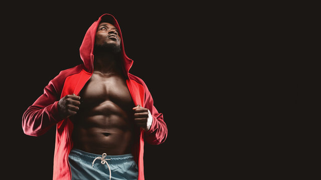 African american muscular boxer in red hoodie - Powered by Adobe