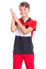 Emotional portrait of caucasian smiling teen boy clapping hands. Happy child joyfully, isolated white background. Handsome funny teenager giving applause.