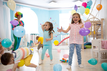 Preschool kids dancing and playing on birthday party