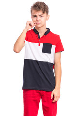 Portrait of handsome teen boy showing sign of closing mouth and silence gesture. My lips are sealed. Child showing zip gesture as if shutting mouth on key. Funny teenager isolated on white background.