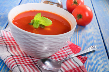 Tomato soup on wooden table.