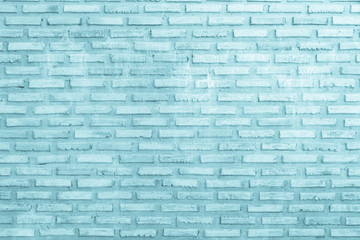 Brick wall painted with pale blue paint pastel calm tone texture background. Brickwork and stonework flooring interior rock old pattern clean concrete grid uneven bricks design.