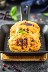 Baked cabbage rissoles in cast iron skillet. Selective focus, copy space.