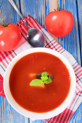 Tomato soup on wooden table.
