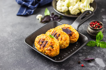 Baked cabbage rissoles in cast iron skillet. Selective focus, copy space.
