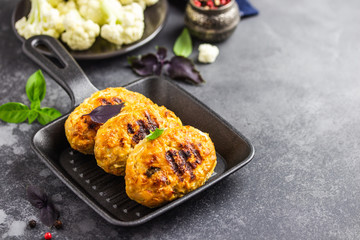 Baked cabbage rissoles in cast iron skillet. Selective focus, copy space.