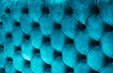 Blue luxury velour quilted sofa upholstery with buttons, elegant home decor texture and background